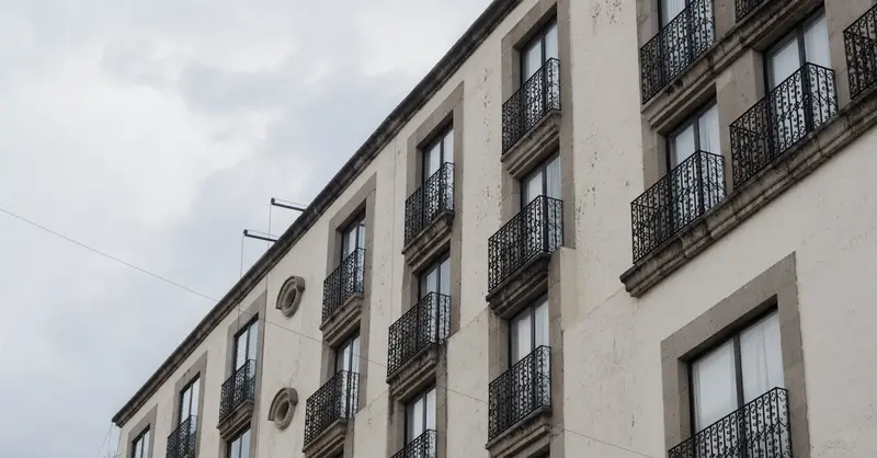 A classic building facade with ornate ironwork balconies in Toluca de Lerdo, Mexico.