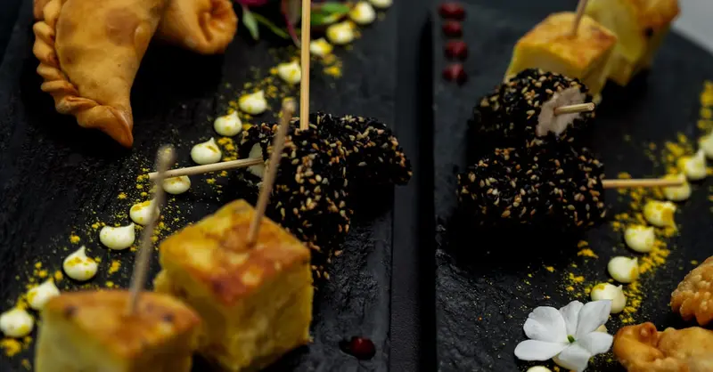 A selection of gourmet Argentinian appetizers elegantly presented on black slate platters.