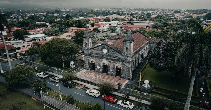 Captivating aerial shot of Iglesia de la Inmaculada in Heredia, Costa Rica, with lush surroundings.