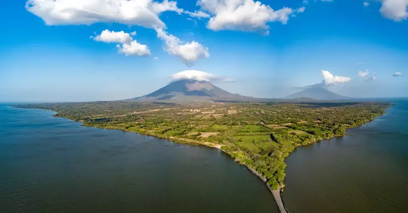 Explore the stunning aerial view of Ometepe Island and its volcanic landscape surrounded by serene waters.