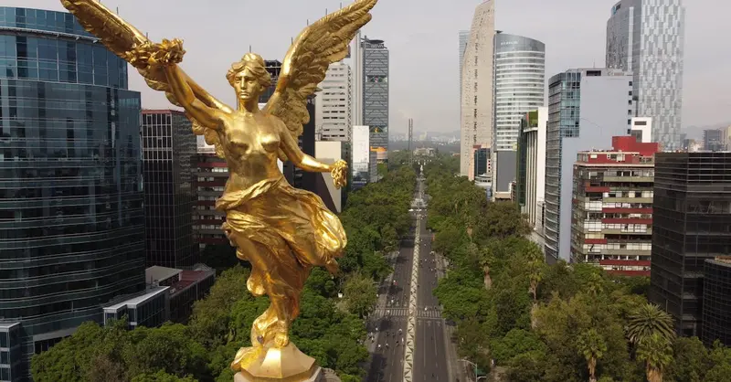 Aerial shot featuring the iconic Angel of Independence in Mexico City's vibrant urban landscape.