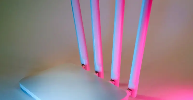 A sleek wireless router enhanced by vibrant neon lights, showcasing cutting-edge technology.