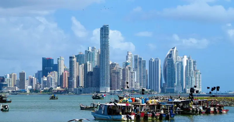 Panama City skyline with boats on the waterfront under a clear blue sky.