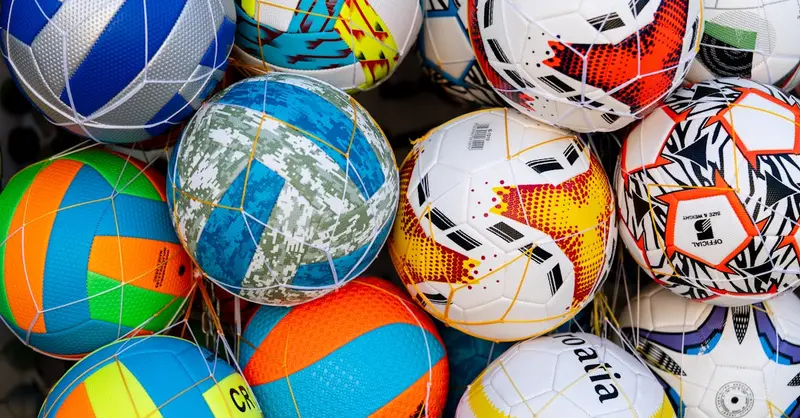 Vibrant collection of soccer balls with various patterns and colors.