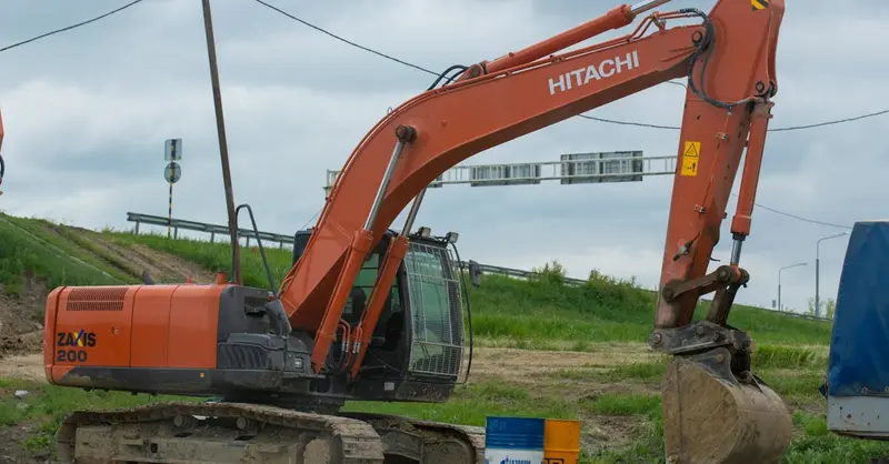 A Hitachi excavator on site, ready for construction work, illustrating heavy machinery in action.