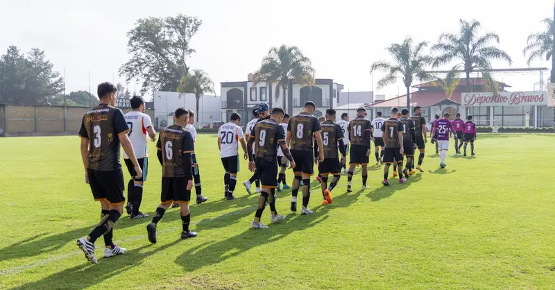 Group of soccer players entering the field at Deportes Bravos stadium, Texcoco, Mexico.