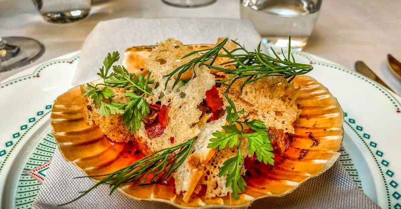 Delicious seafood dish garnished with fresh herbs, served elegantly in Stockholm, Sweden.