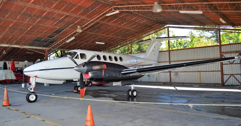 Private airplane parked in a spacious hangar in Ilopango, San Salvador.