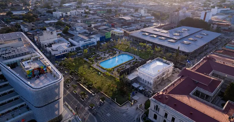 Explore San Salvador with this captivating aerial view at sunset showcasing vibrant city life.