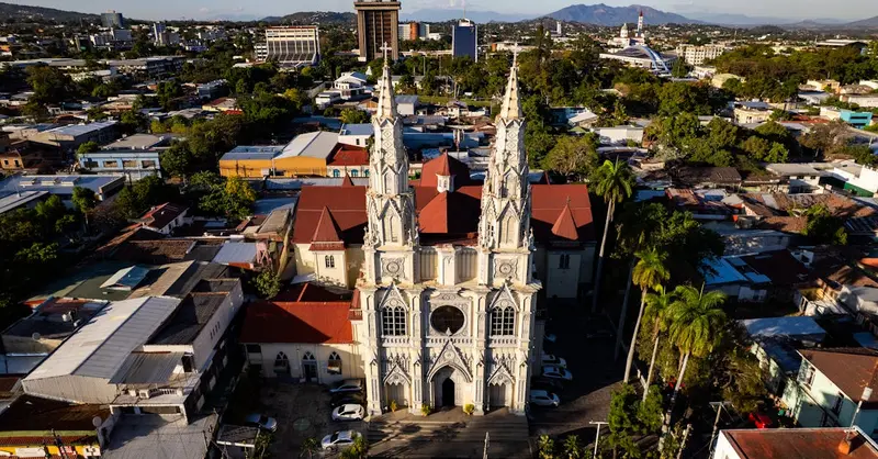 Aerial view of El Rosario Church in San Salvador, showcasing its stunning architecture amidst urban surroundings.