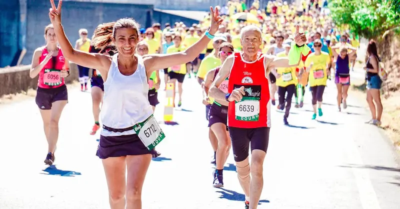 A group of diverse runners participating in a lively marathon event under the sun.