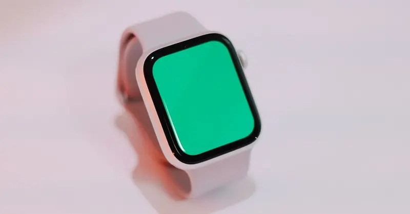 Smartwatch with a blank green screen displayed on a light background, suitable for mockups.