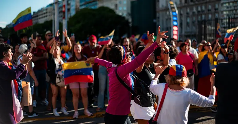 A joyous Venezuelan gathering in Buenos Aires, celebrating with flags and unity.