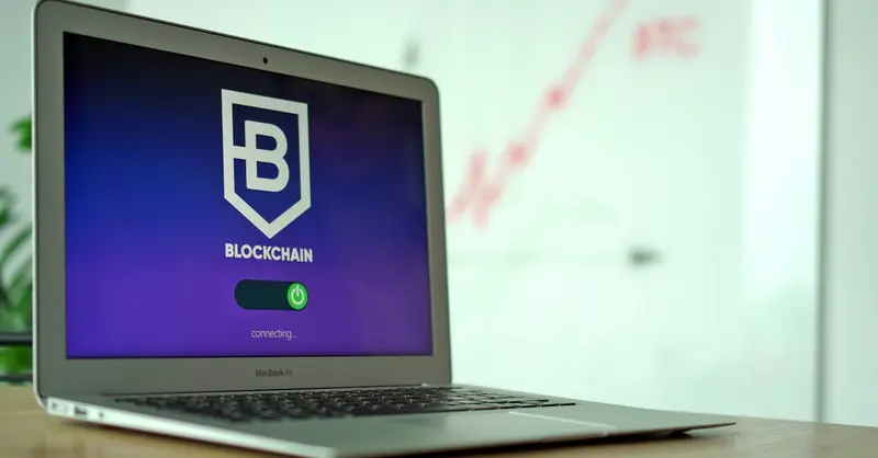 MacBook Air showing a blockchain application interface in an office setting.